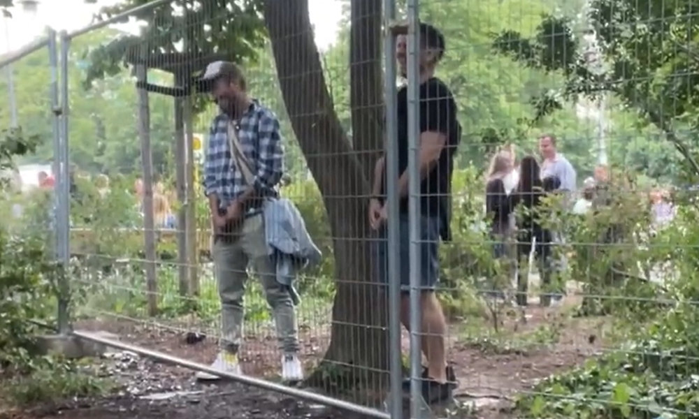 guys caught peeing in public at the music festival