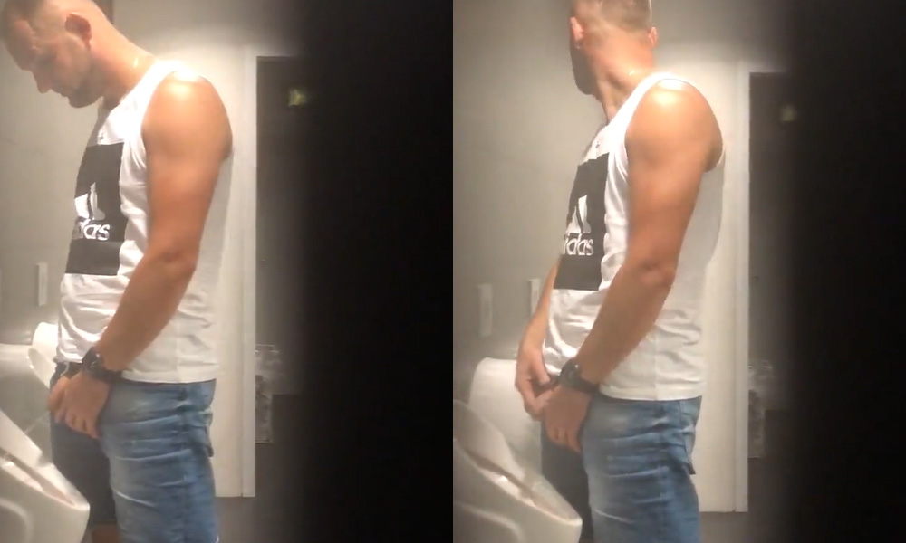 handsome guy in tank top caught pissing at urinals