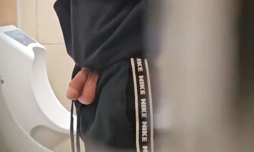 Guy with huge fat cock peeing at urinals with balls out