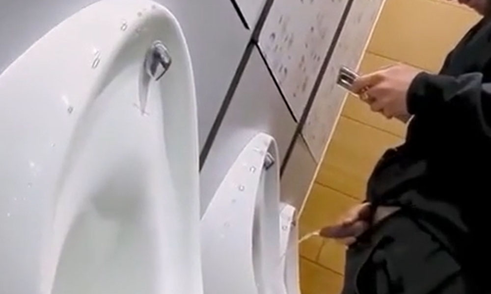 Uncut guy caught peeing while texting at the urinals