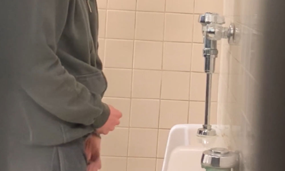 Sexy guy caught taking a leak at urinals