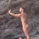 naked muscled stud taking selfies at the nudist beach